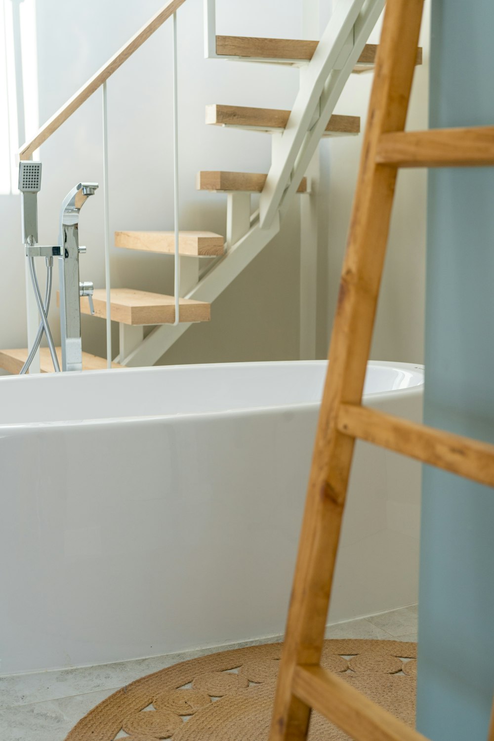 a bathroom with a ladder next to a bathtub