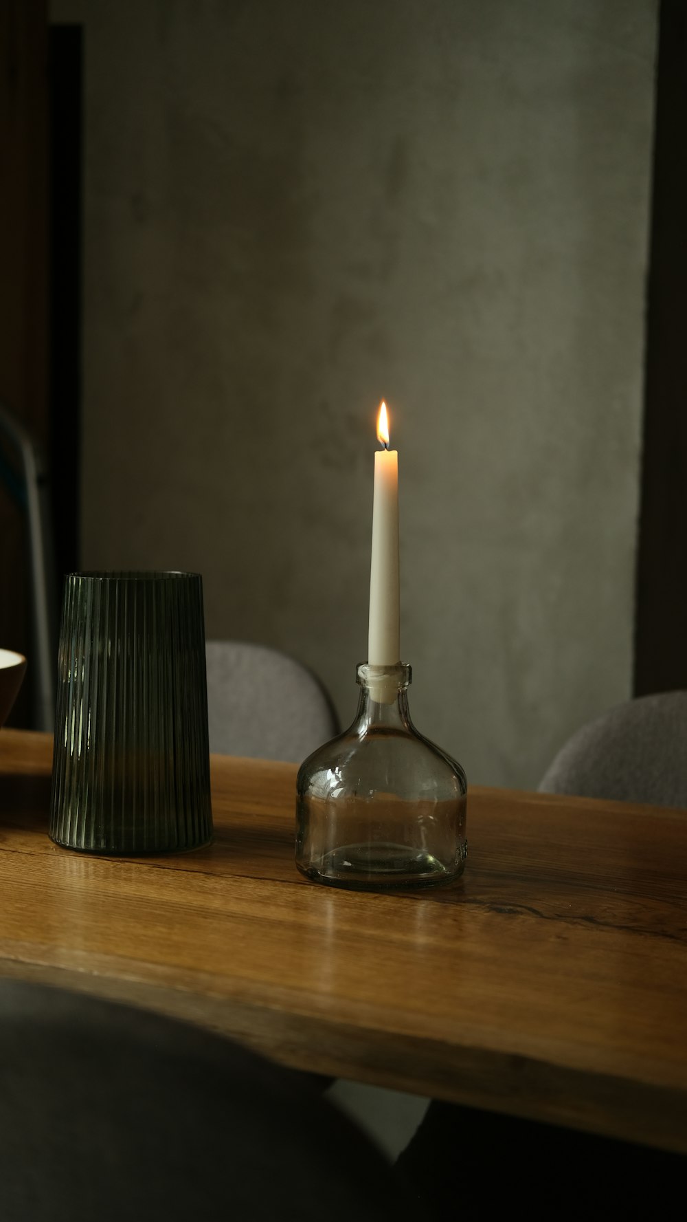 a lit candle sitting on top of a wooden table