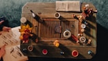 Detail of handcrafted artistic objects arranged on a wooden table.