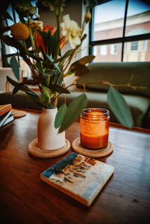 cozy candle lighting creating a warm relaxing home atmosphere on wooden table with soft decor.