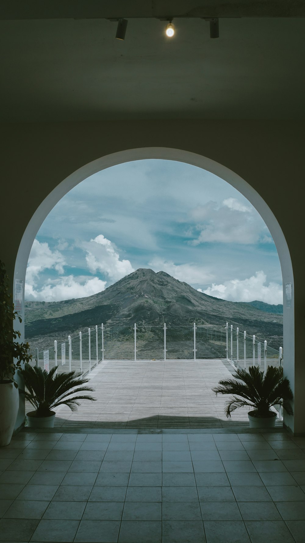 a view of a mountain through an arch in a building