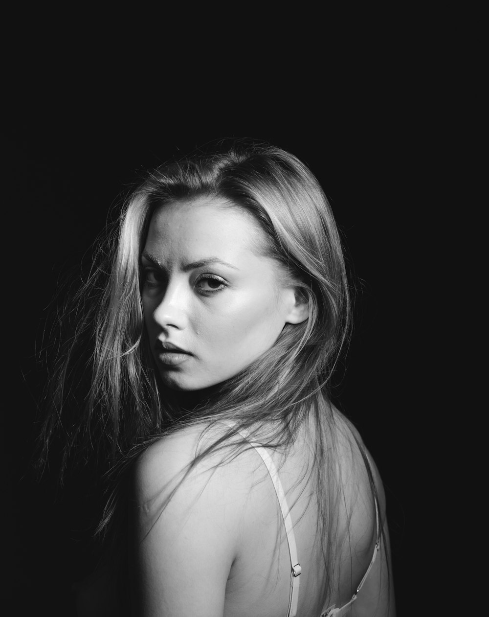 a black and white photo of a woman with long hair