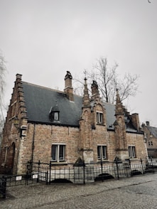 a large brick building with a black fence around it