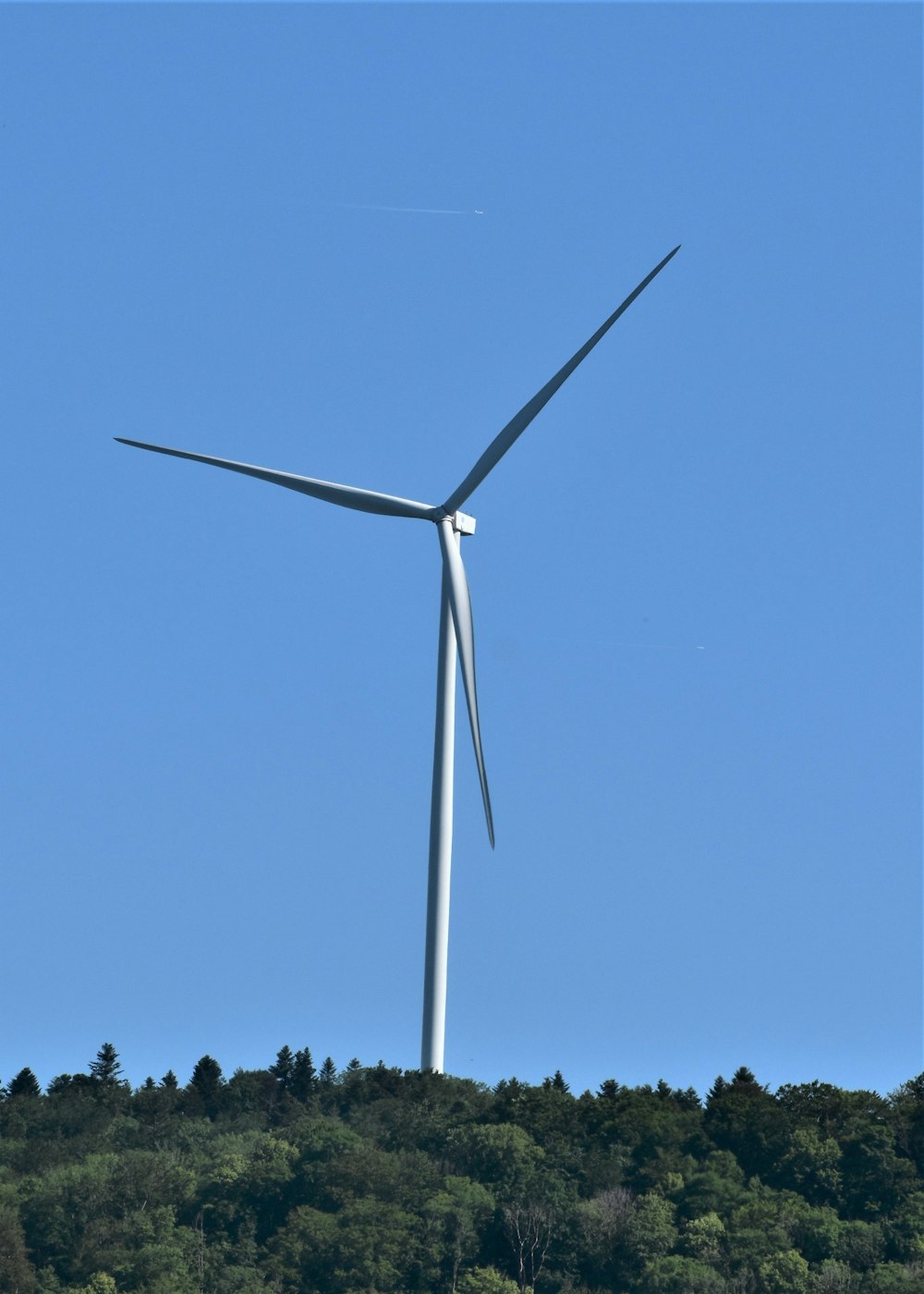 a wind turbine on top of a hill