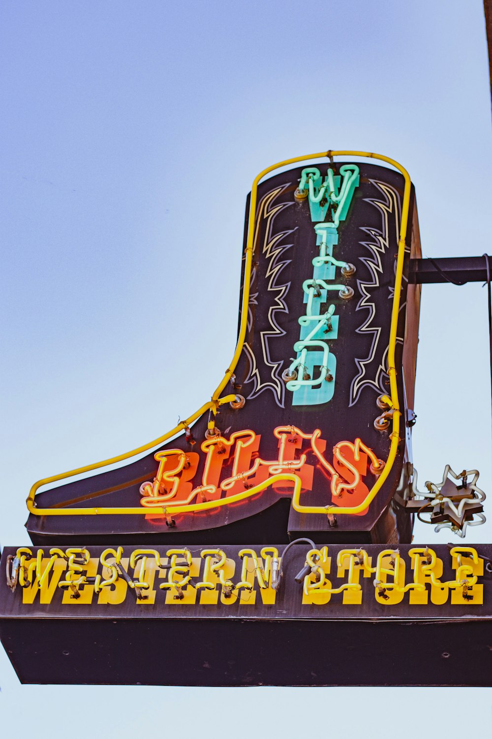 a neon sign for a western store on a building