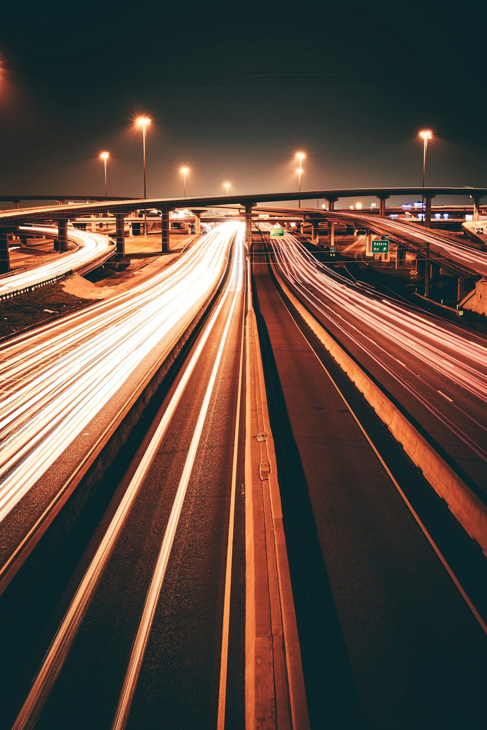 a long exposure photo of a highway at night