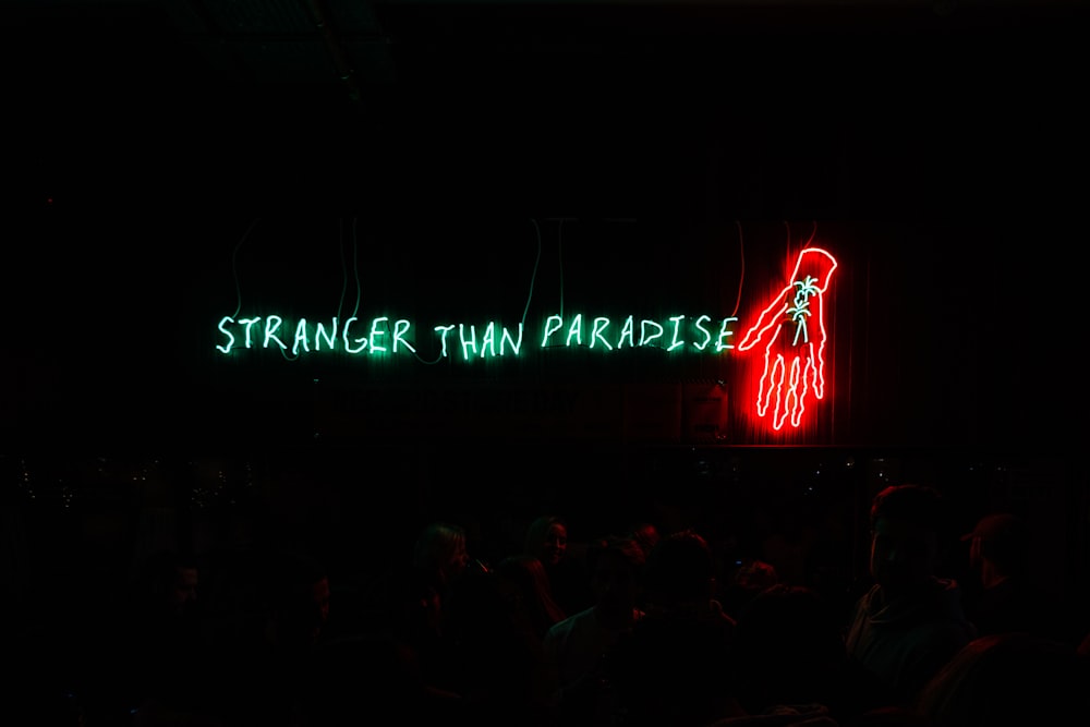 a neon sign that reads, strange twin paradise