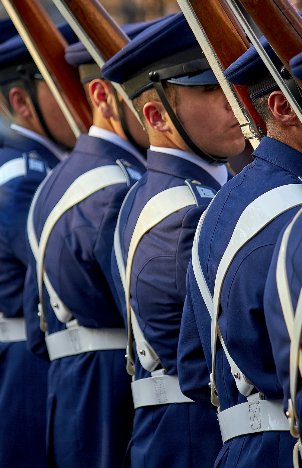 a group of men in blue uniforms holding guns