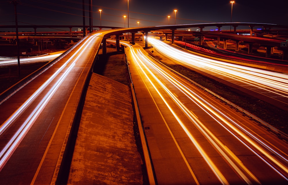 a long exposure photo of a highway at night