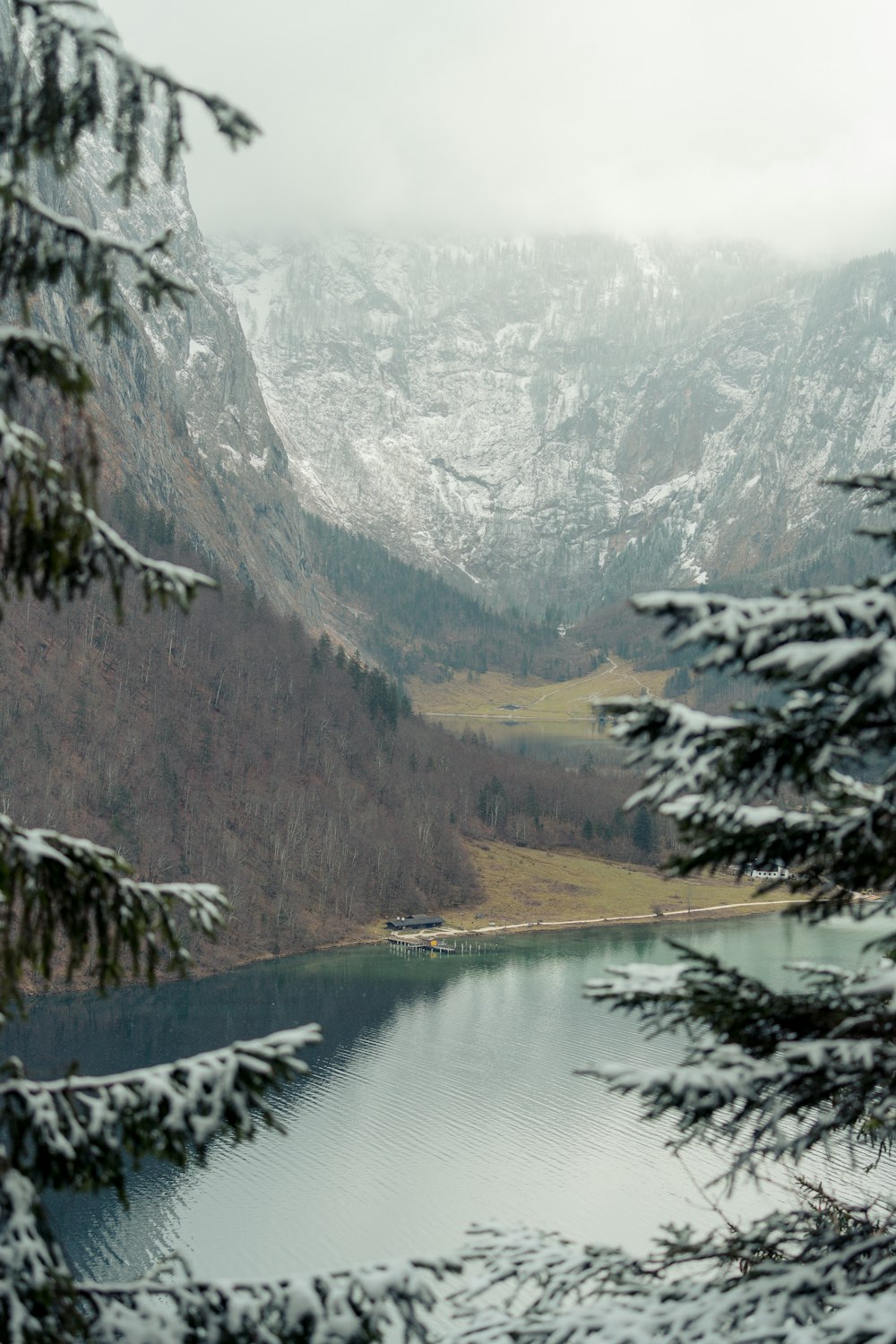 a lake surrounded by snow covered mountains