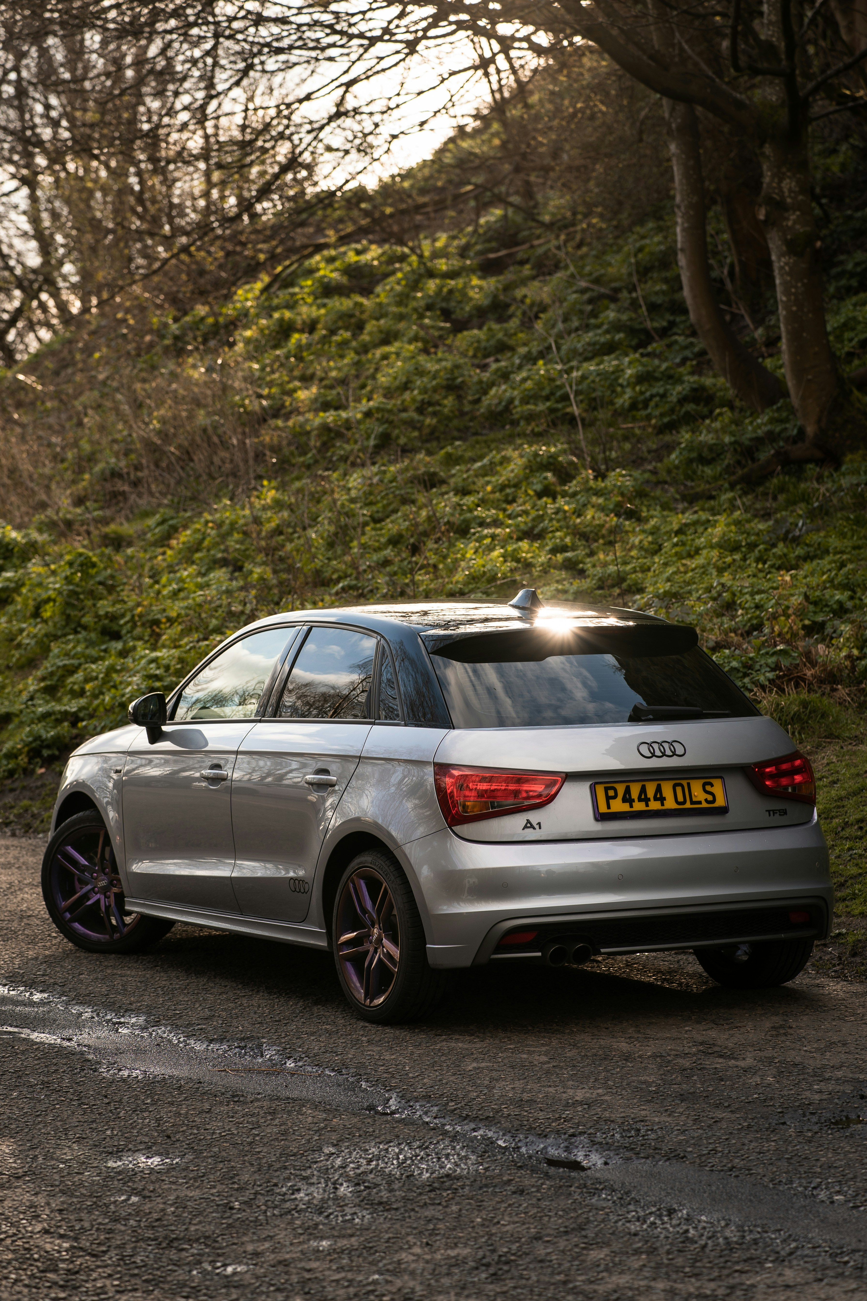 a silver car parked on the side of a road