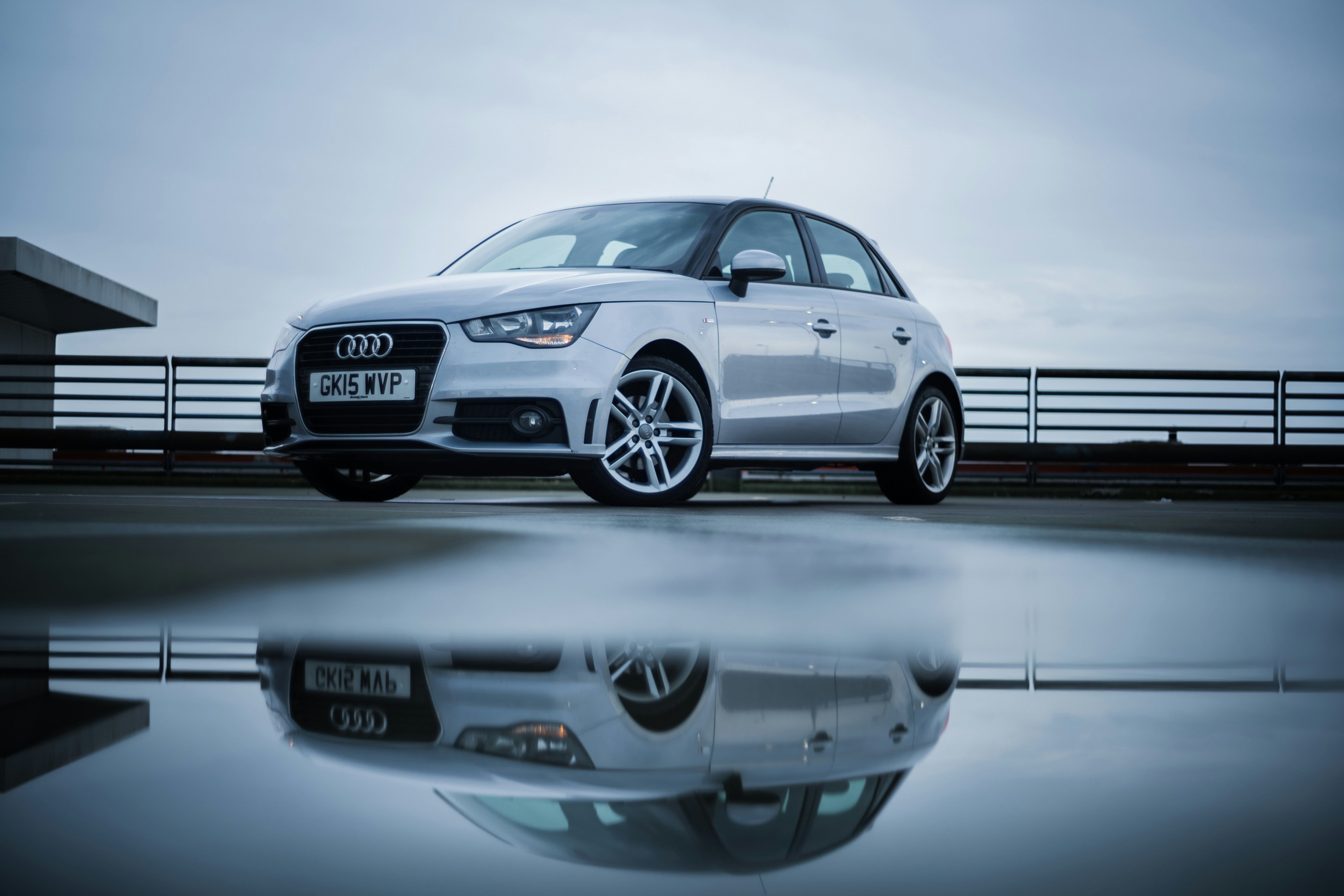 a white car parked in front of a building