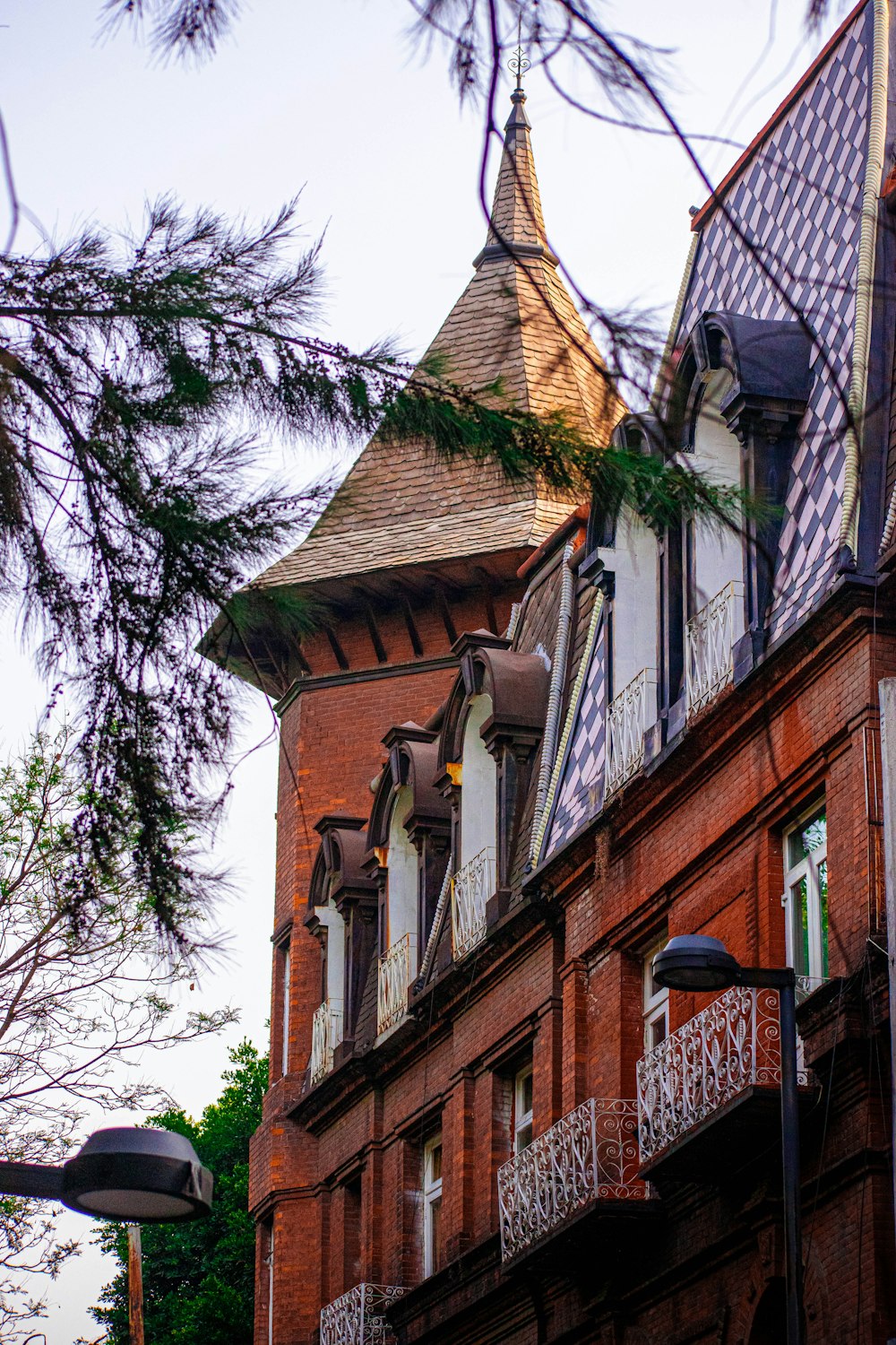 a tall red brick building with a clock tower