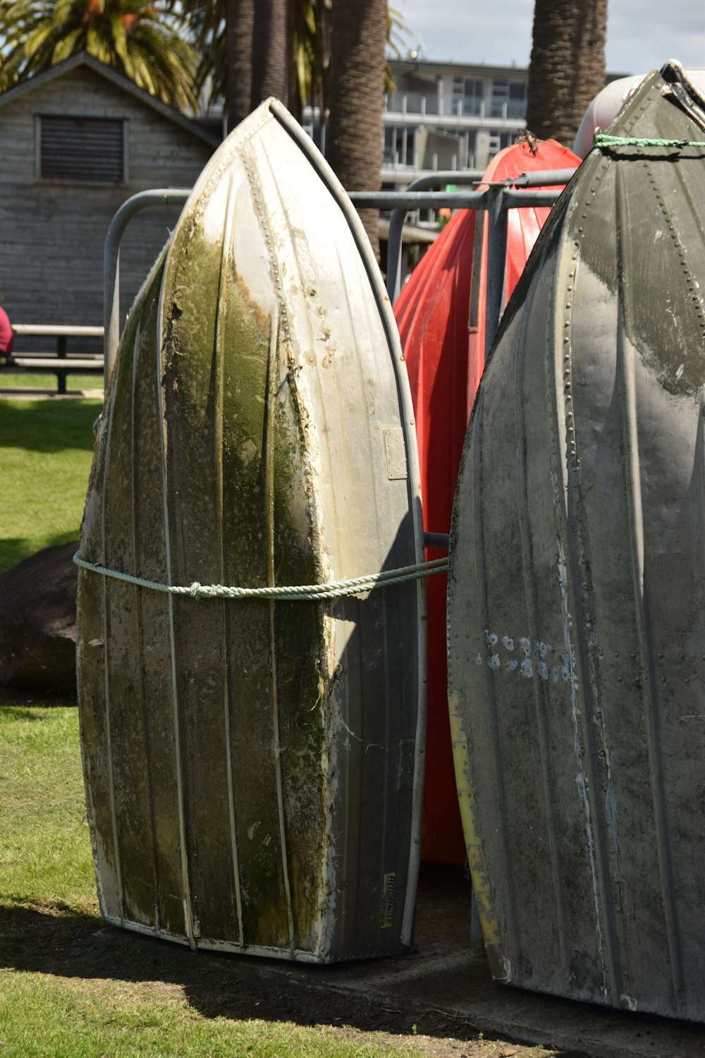 a couple of boats that are sitting in the grass