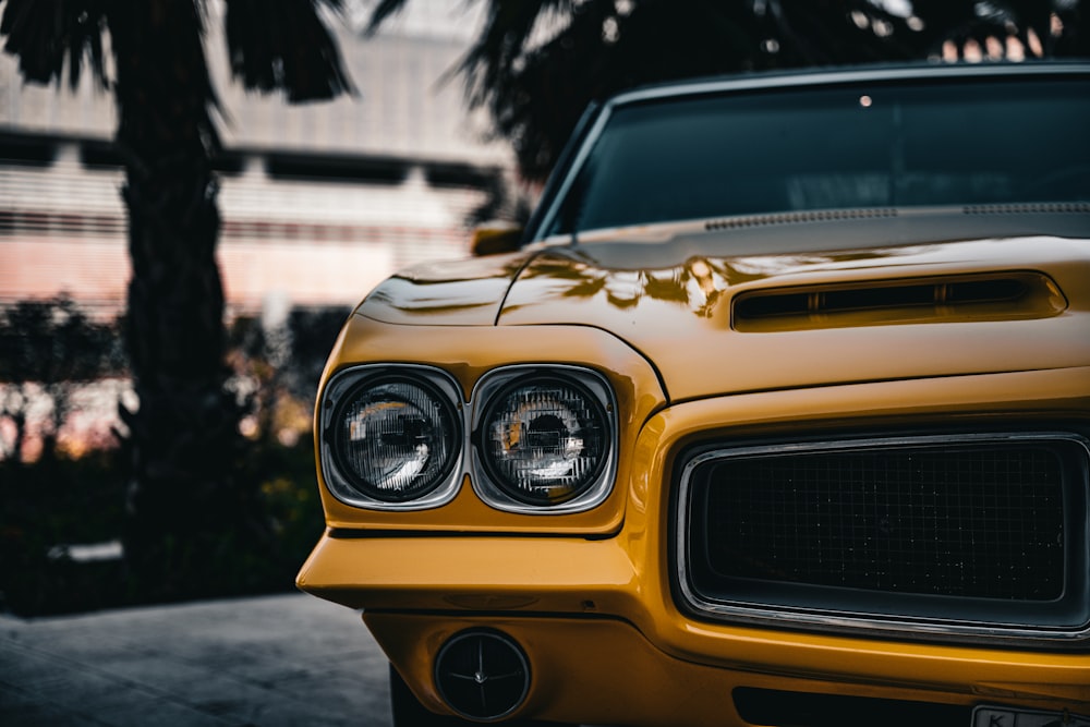 a close up of the front of a yellow car