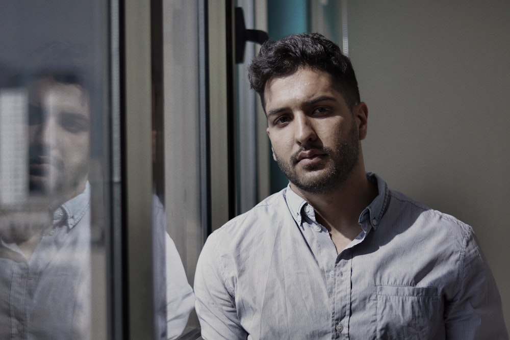 a man standing in front of a window