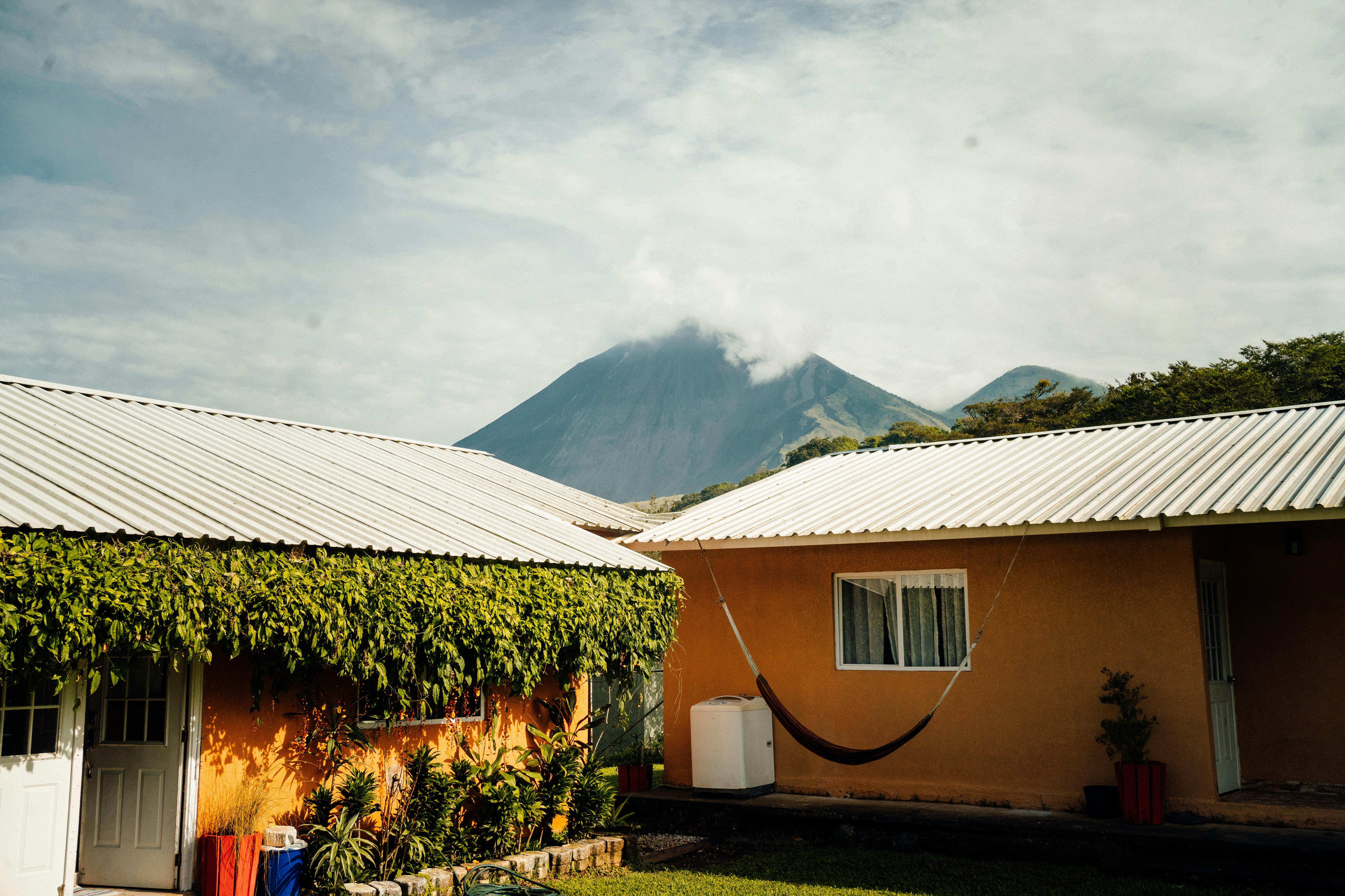 a house with a hammock hanging from it's roof