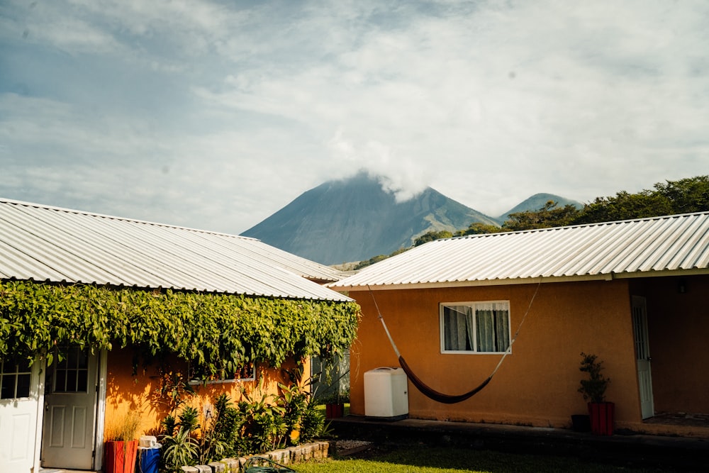 a house with a hammock hanging from it's roof