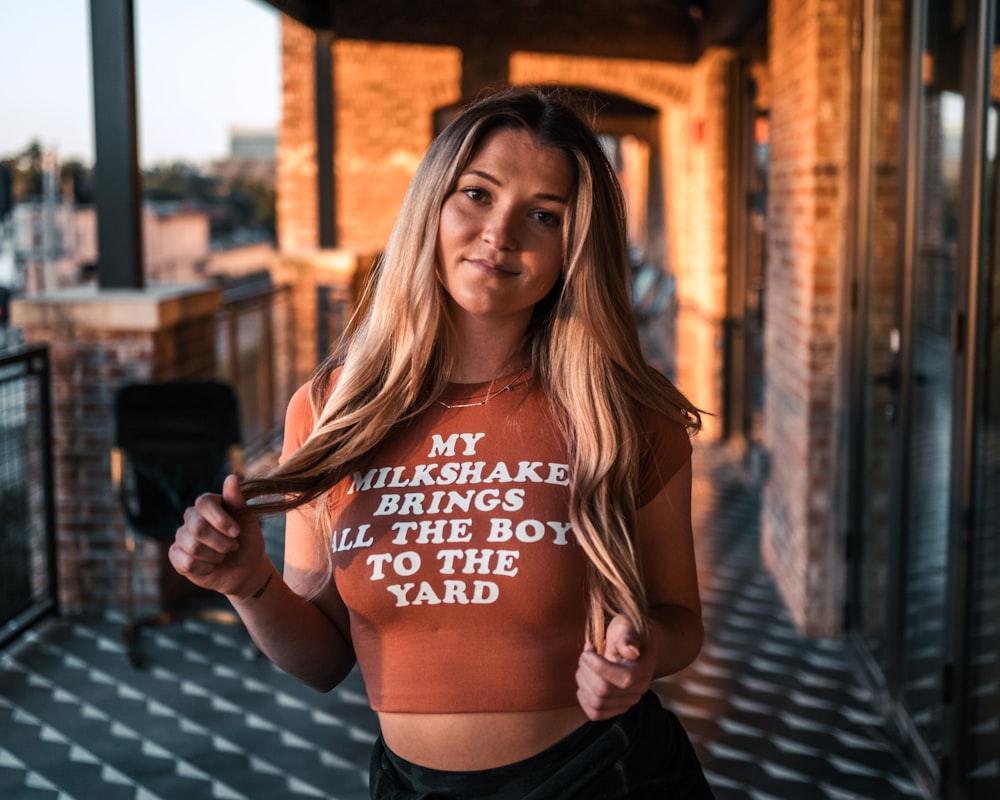 a woman with long hair wearing a crop top