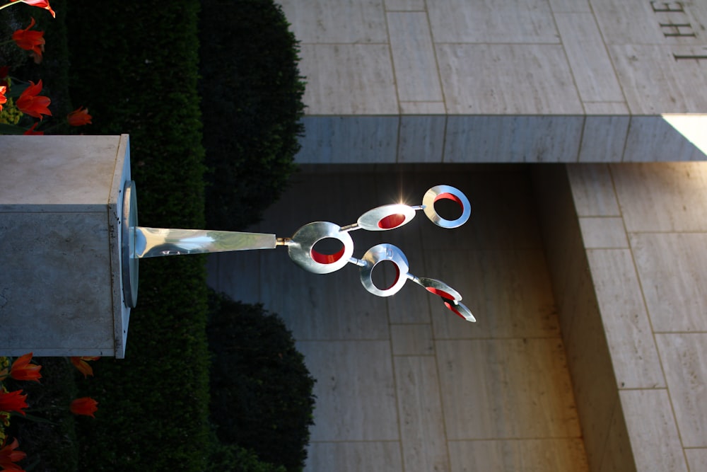 a sculpture in front of a building with a building in the background