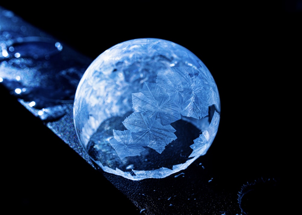 a blue crystal ball sitting on top of a table