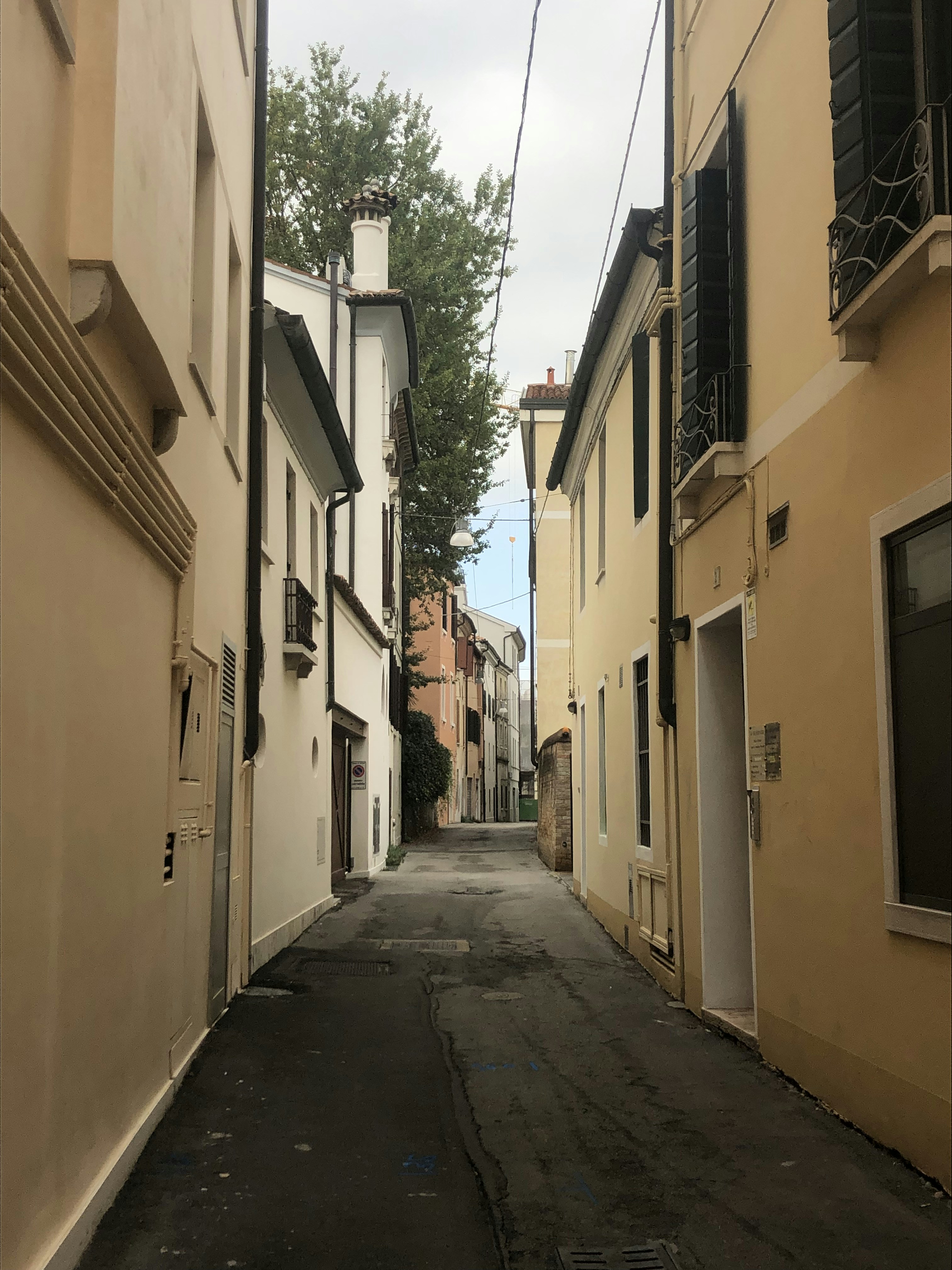 a narrow city street with buildings on both sides