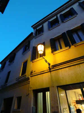 Evening exterior shot of Lulu & Co with soft golden lights glowing against the dark facade.