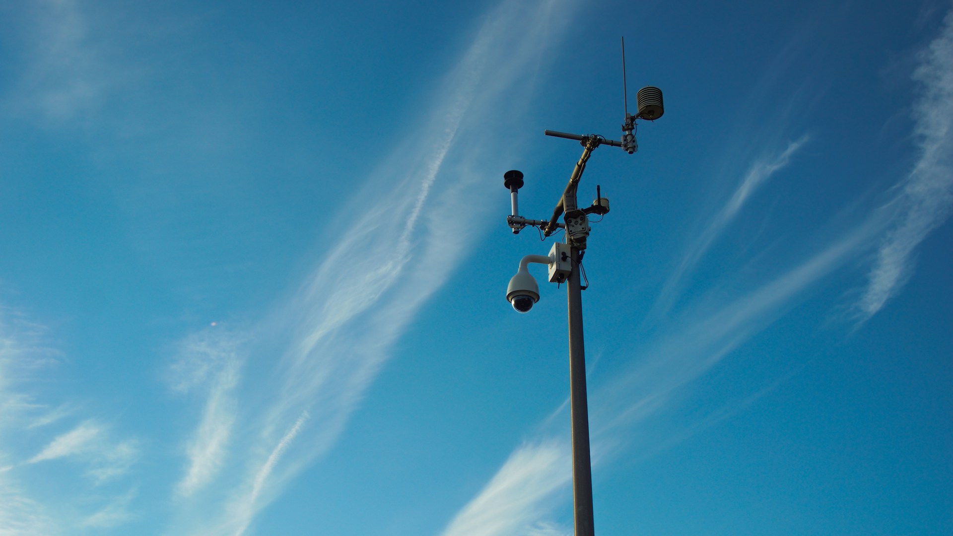 a couple of street lights sitting next to a tall pole
