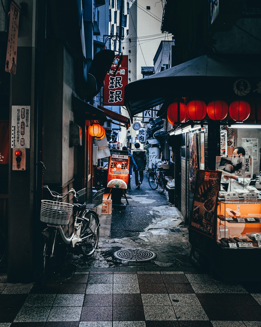 a narrow alley with a bike parked on the side of it