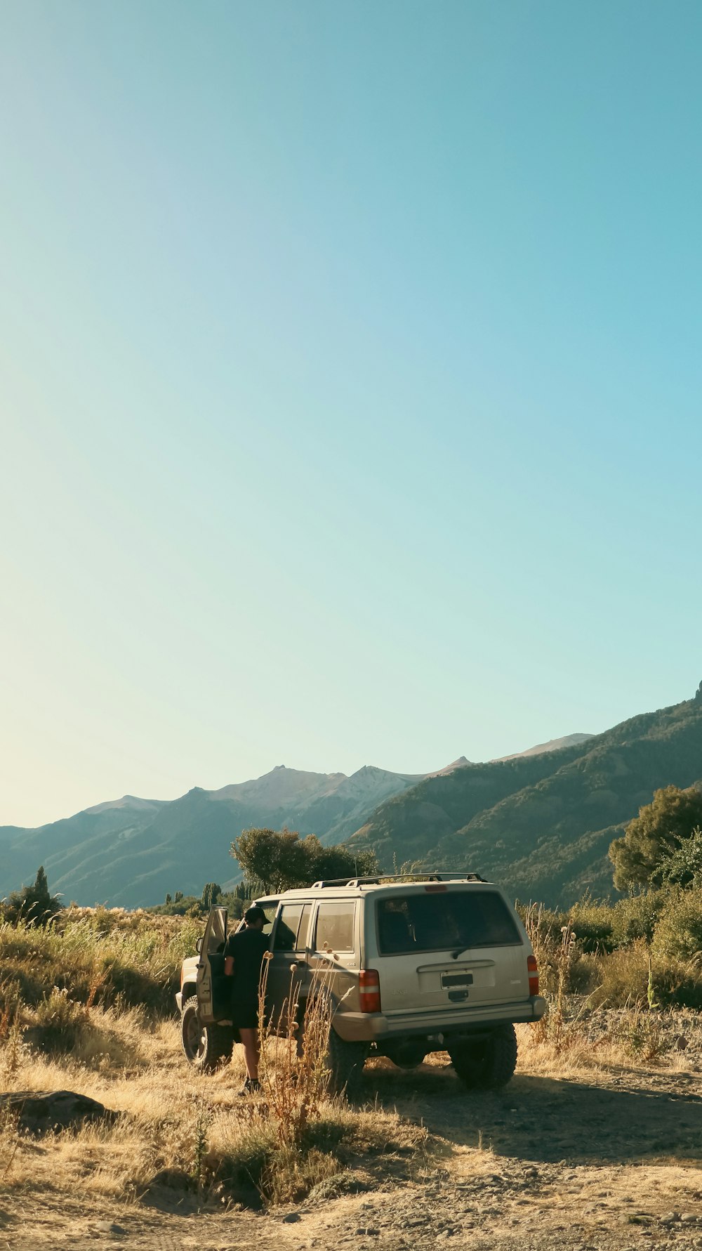 a van parked on a dirt road in the mountains