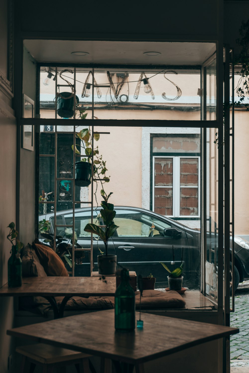 a car is seen through the window of a coffee shop