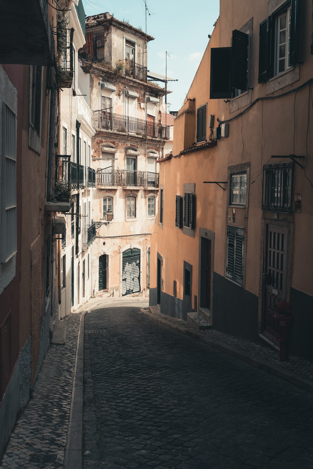 a narrow cobblestone street lined with buildings