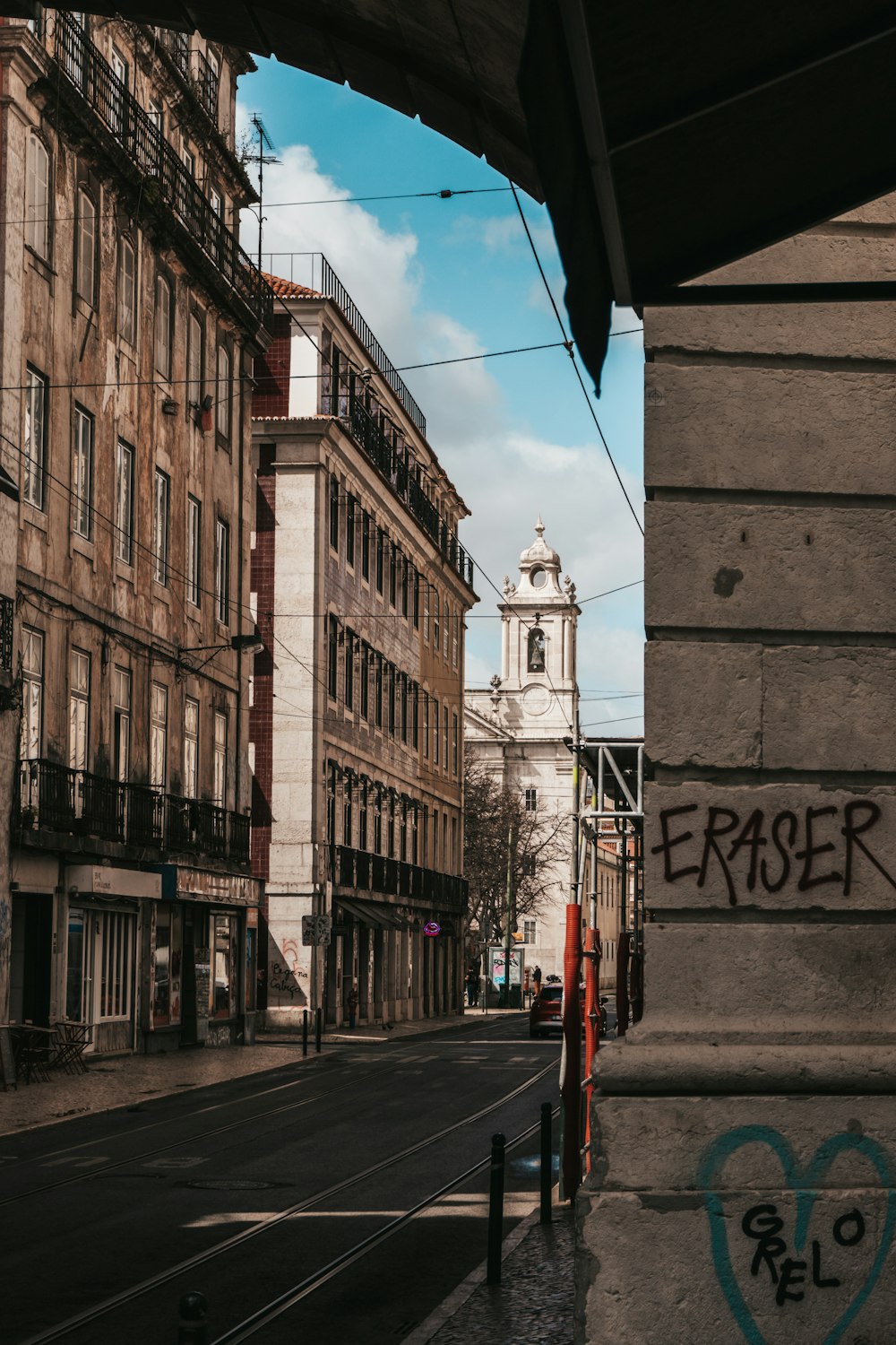 a view of a city street with graffiti on it