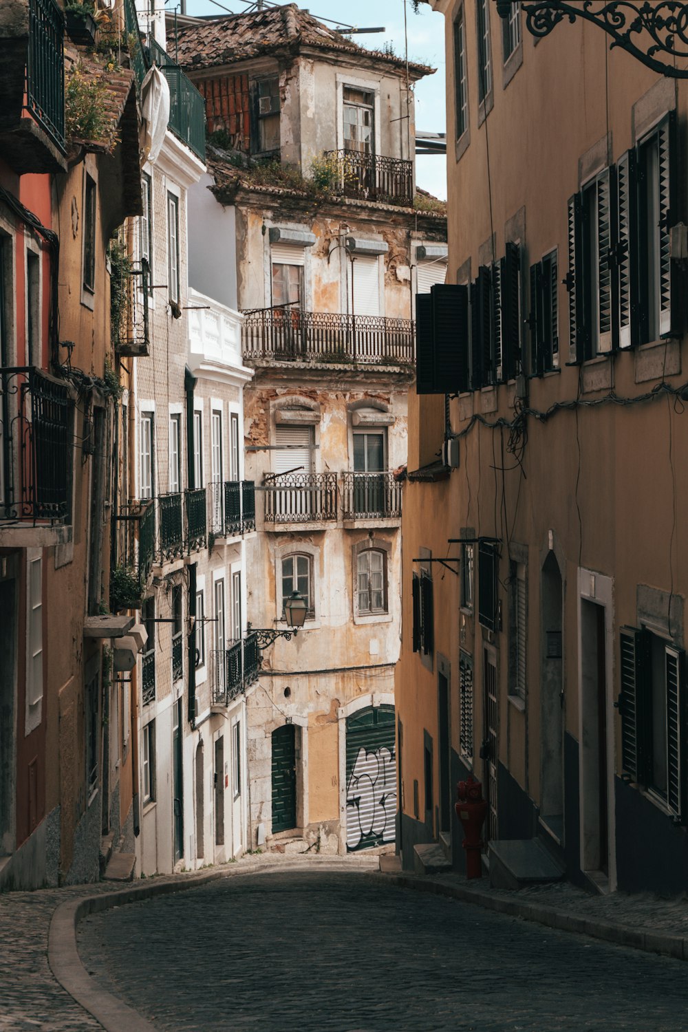 a narrow street with buildings and balconies