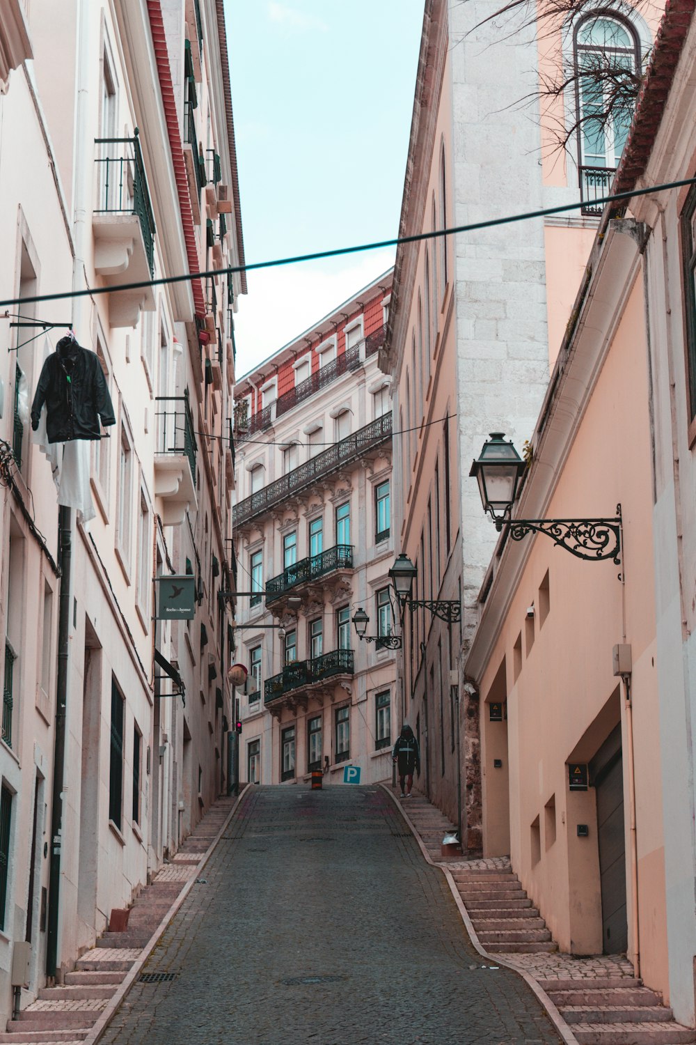 a narrow street lined with tall buildings