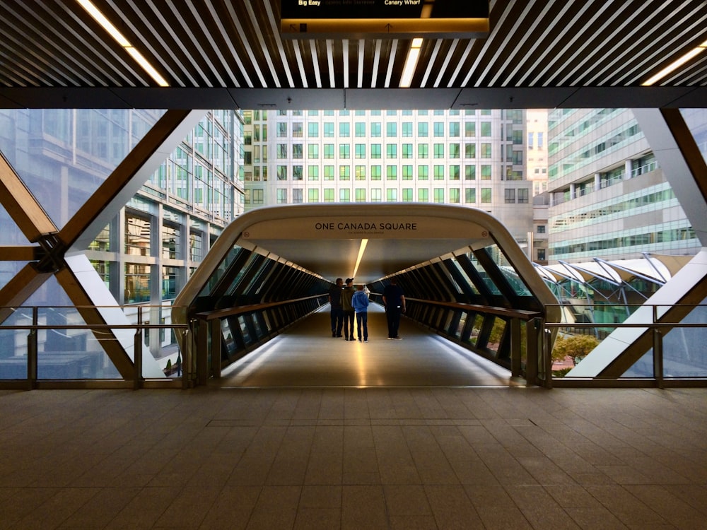 a couple of people are walking down a walkway