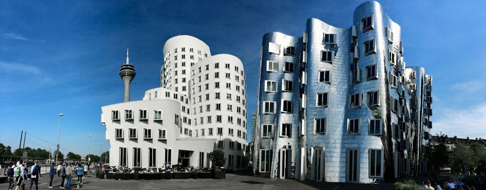 a group of people standing in front of a tall building