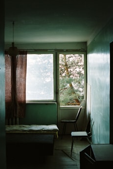 A calm, green-themed therapy room with comfortable chairs and soft lighting, reflecting a safe space for mental health support.