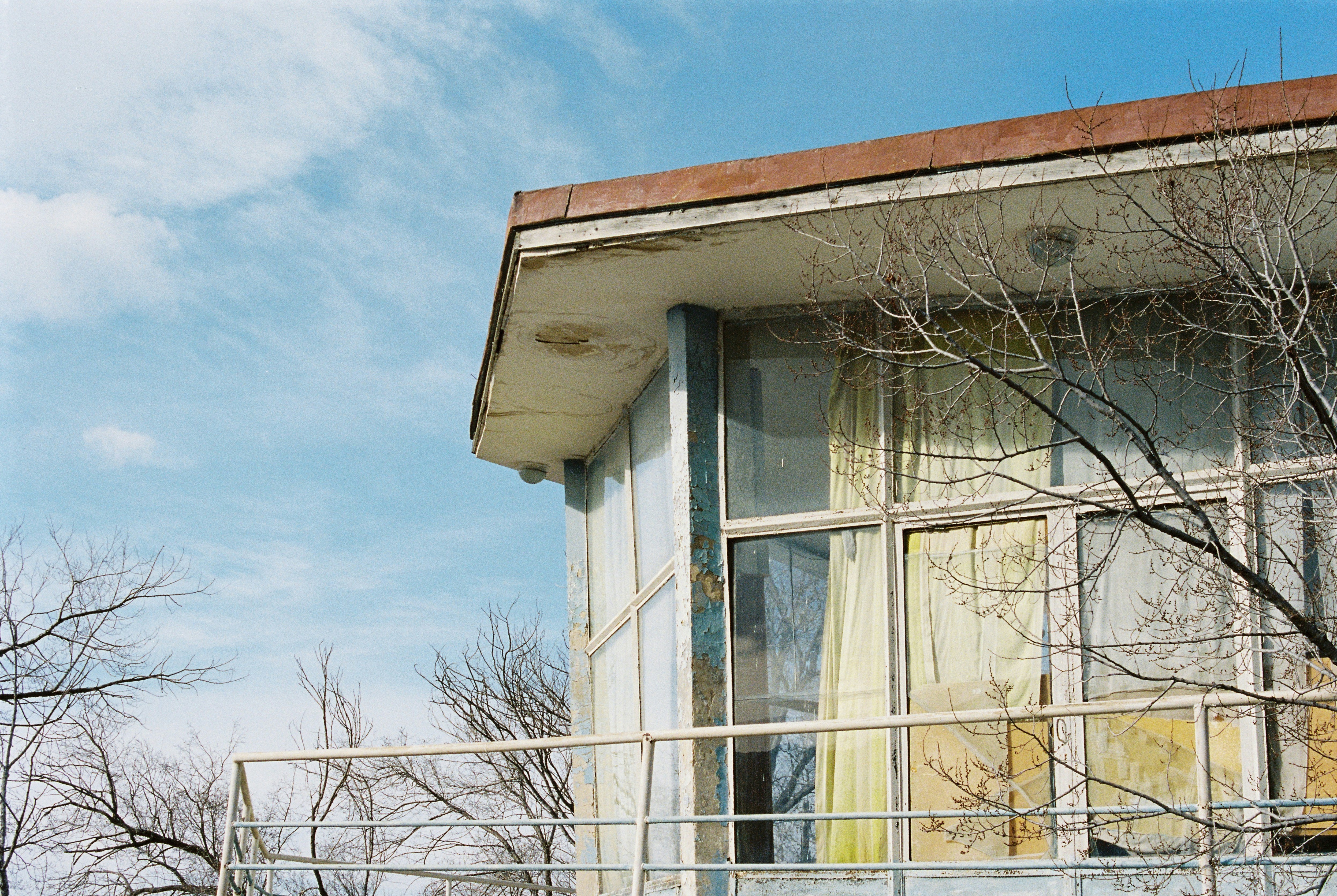 an old run down building with a broken window