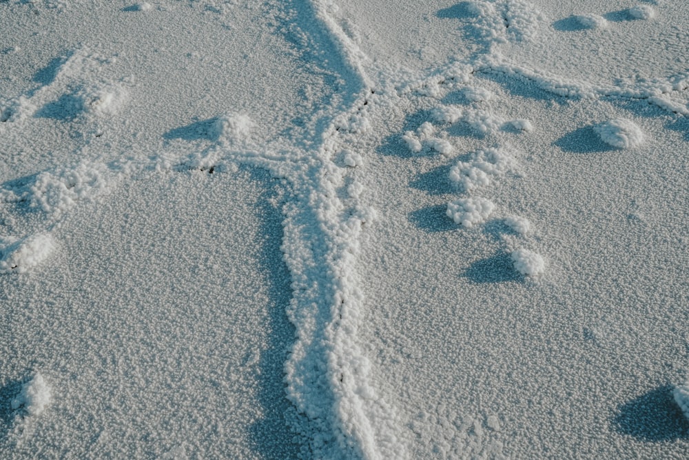 a cross made out of footprints in the snow
