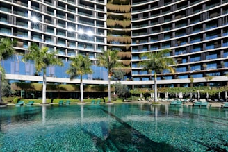 a large building with a pool in front of it