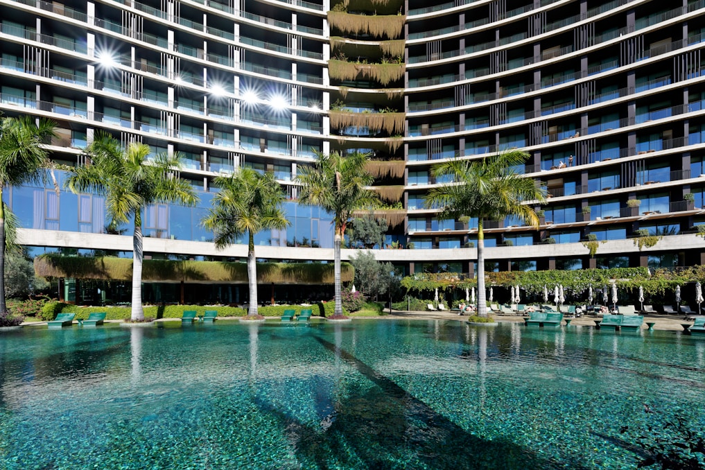 a large building with a pool in front of it