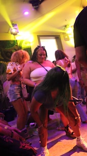 Guests enjoying a lively social event with candid laughter and dancing.