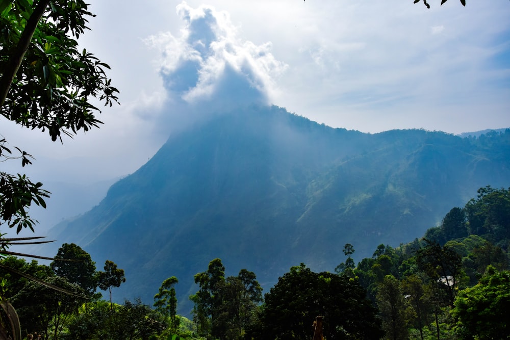 a very tall mountain covered in a cloud