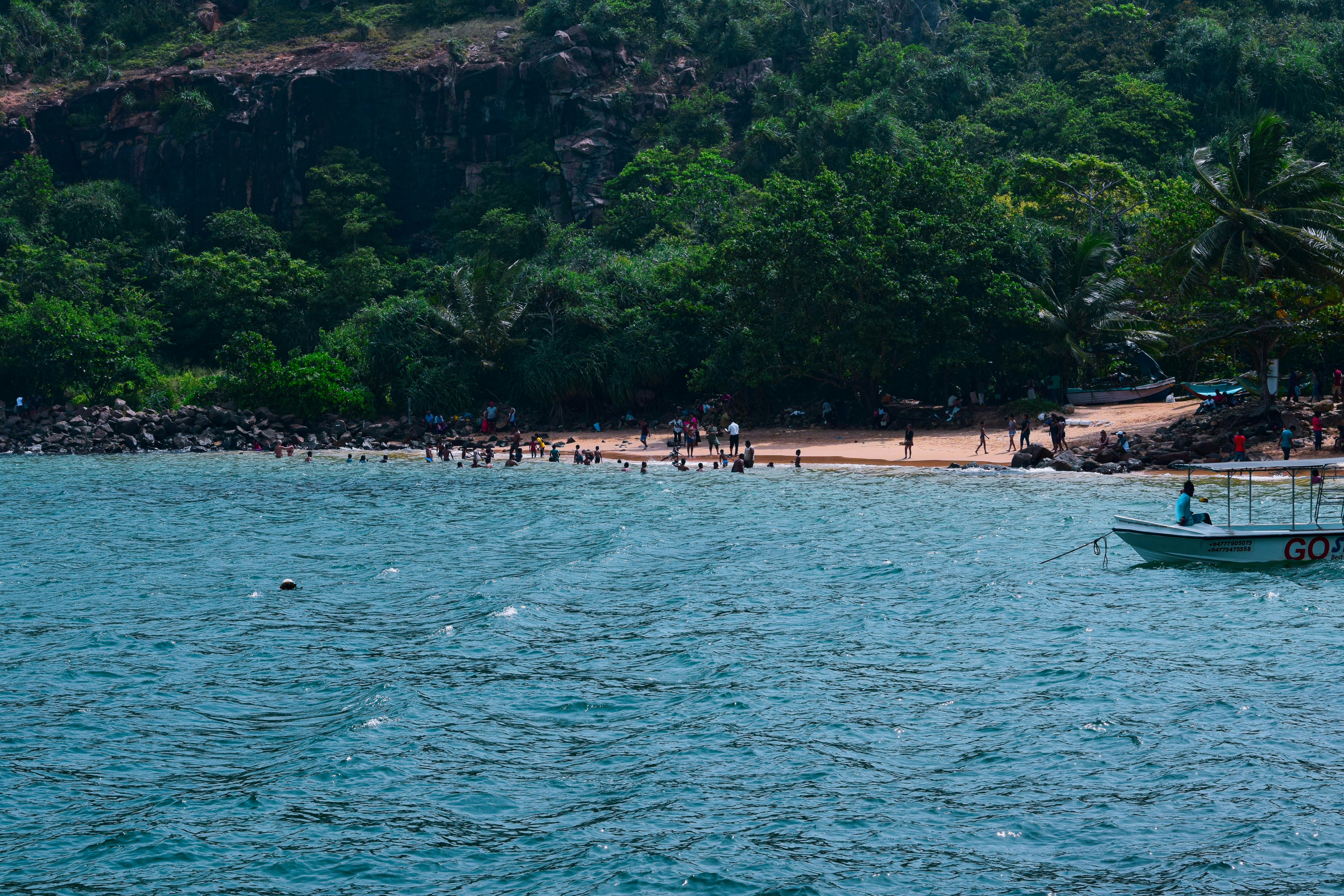 a boat on a body of water near a beach
