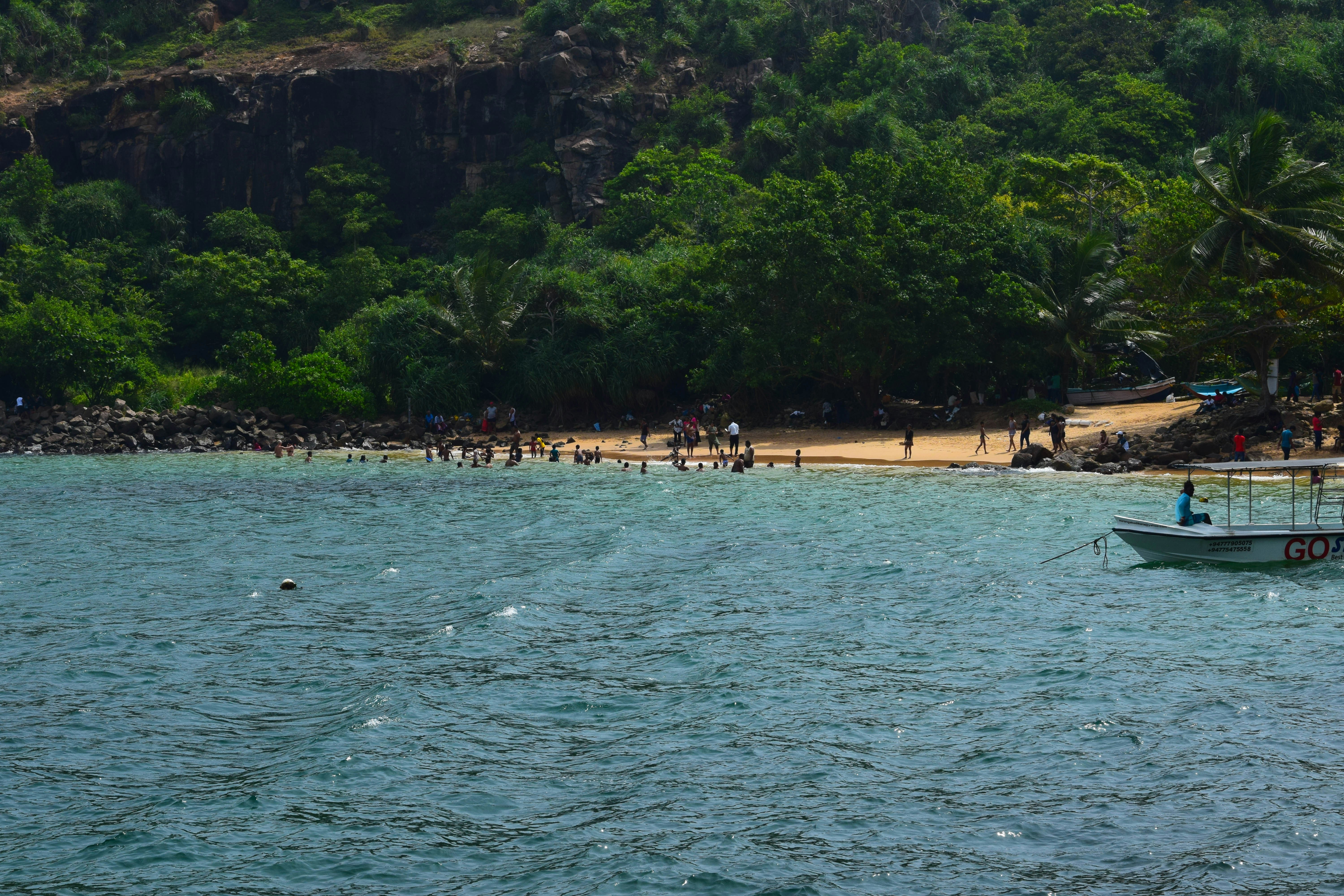 a boat on a body of water near a beach