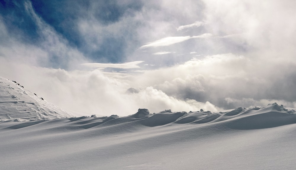 a person riding skis down a snow covered slope