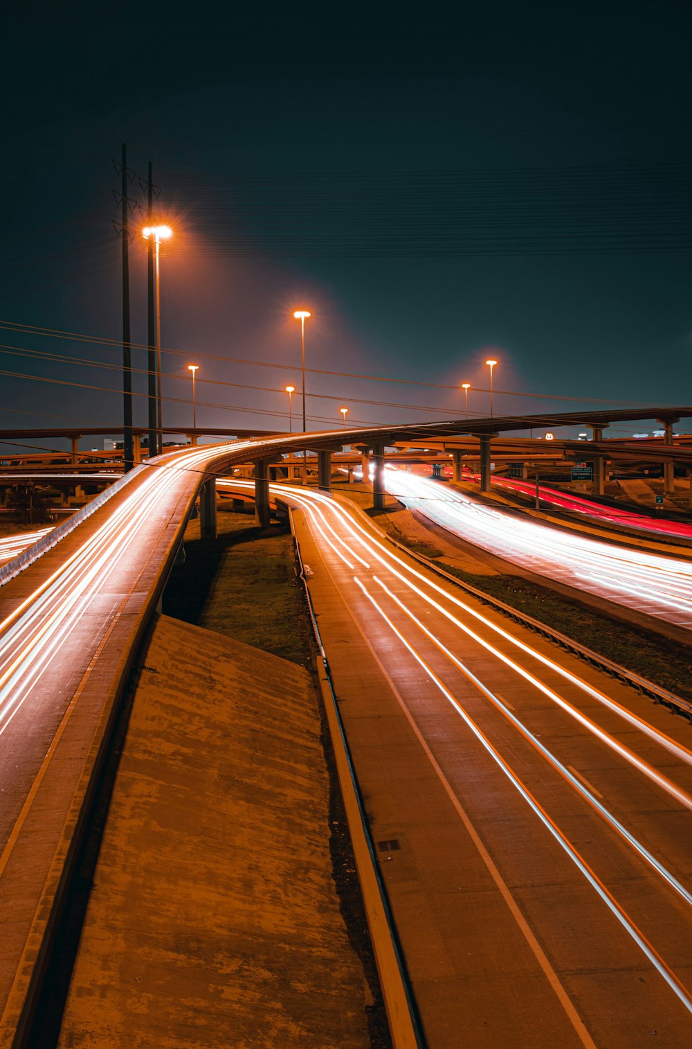 a long exposure photo of a highway at night