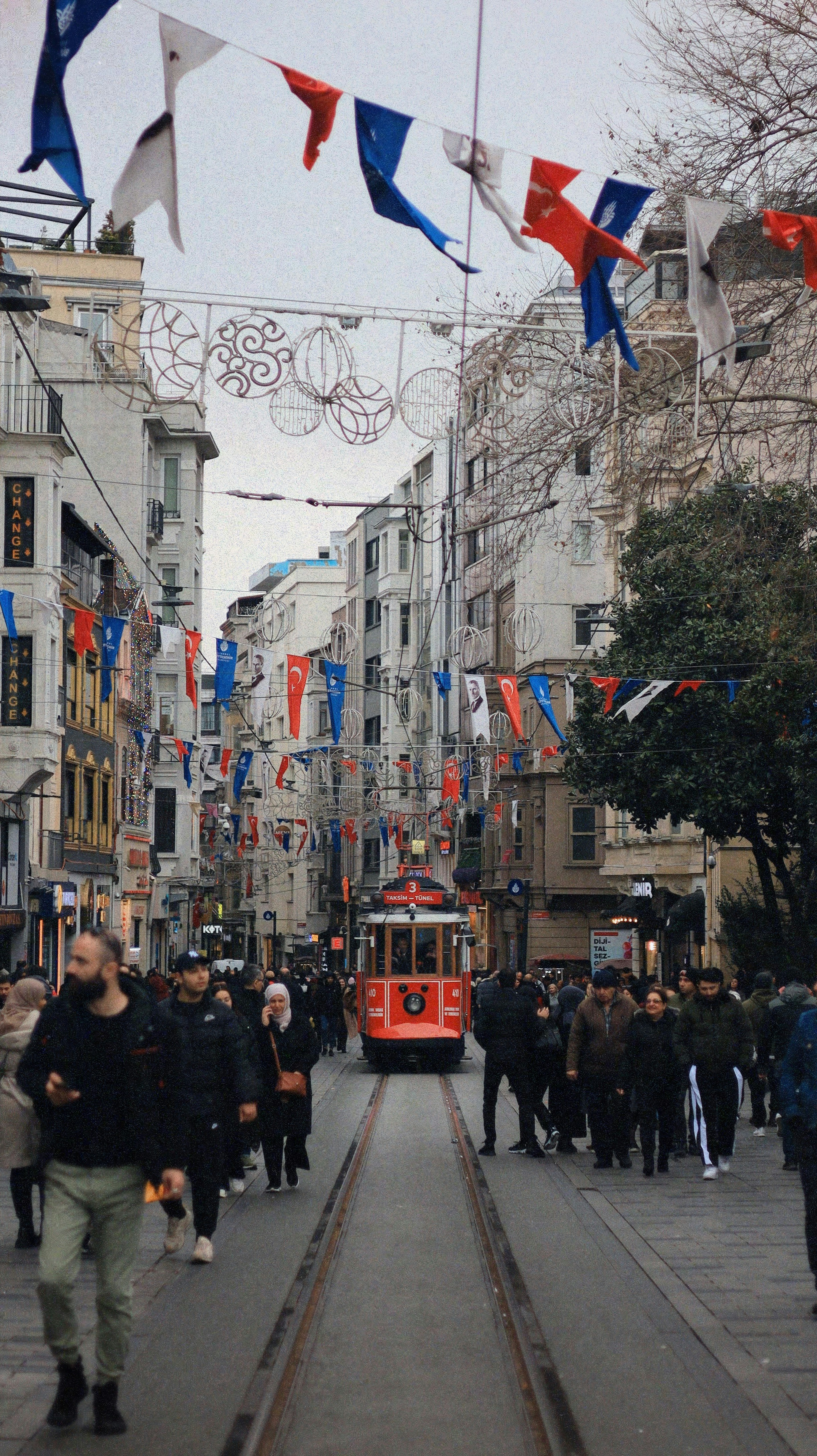 A red trolley car on a city street