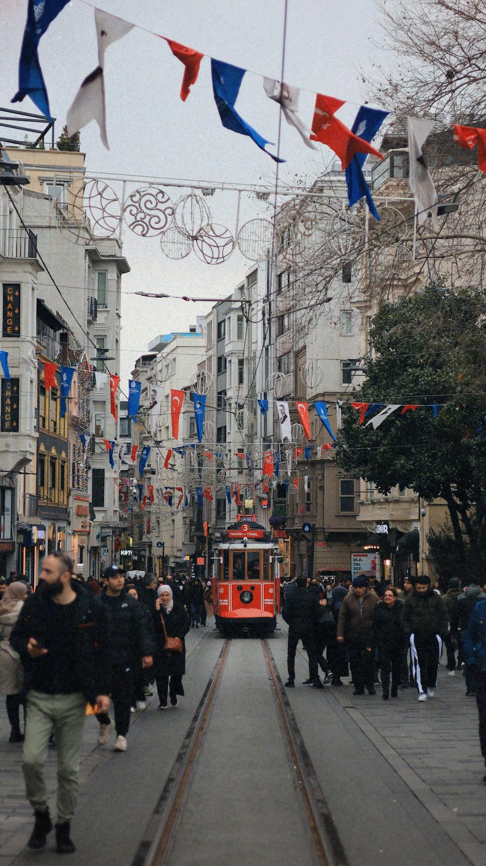 a red trolley car on a city street